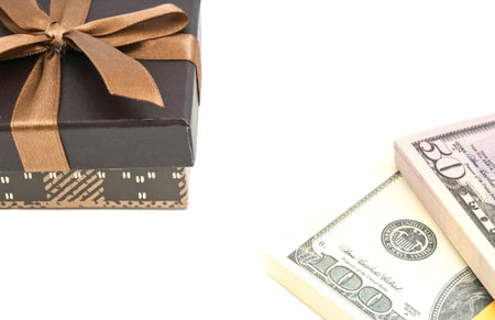 brown gift box and banknotes on white background closeup