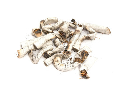 heap of cigarette butts with filter on white background
