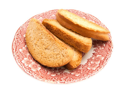 heap of crackers on a plate on white background