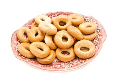 many bagels on a plate closeup on whiteの写真素材
