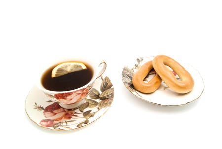 two bagels and cup of tea with Lemon on whiteの写真素材