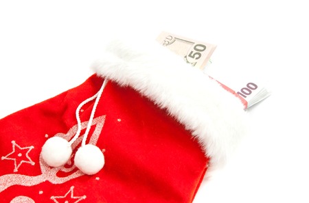 red mitten of Santa Claus and banknotes on white backgroundの写真素材