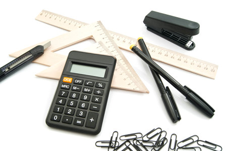 calculator, ruler and other stationery on white background