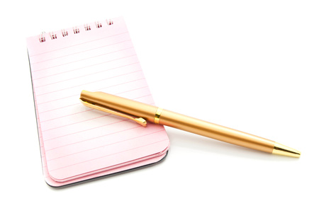 pink notepad and golden pen closeup on whiteの写真素材