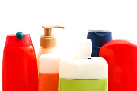 colored bottles with gel and shampoo on white closeupの写真素材