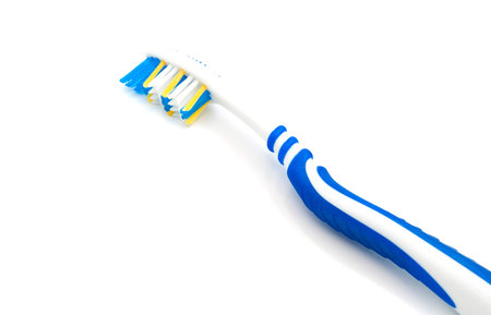 single blue toothbrush on white background closeup