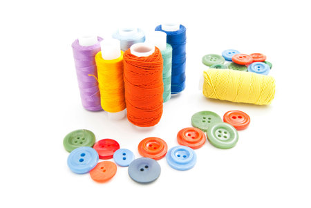 spools of thread and buttons on white