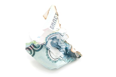 charred russian banknote on white background closeupの写真素材