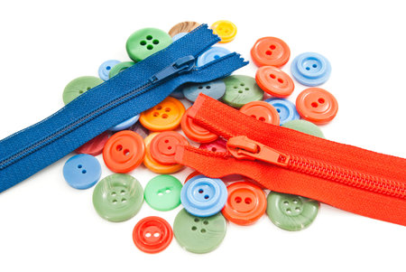 colorful buttons and zippers on white background