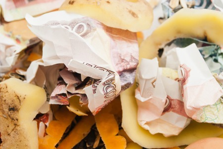 different garbage and russian banknotes closeup backgroundの写真素材