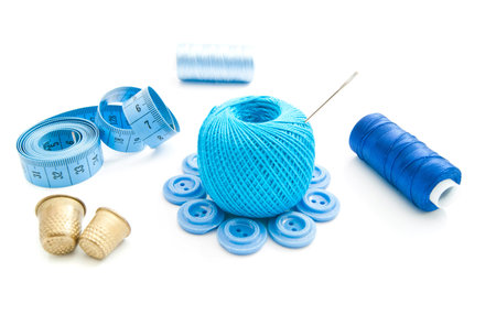 meter, buttons, thimbles and thread on whiteの写真素材
