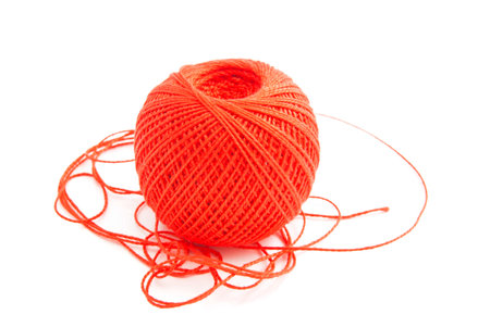 spool of red thread on white backgroundの写真素材