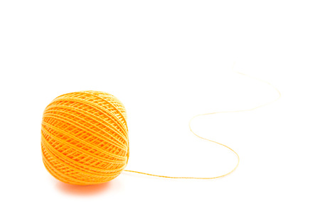 ball of orange thread on white backgroundの写真素材