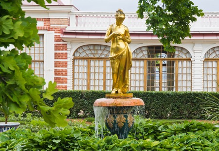 golden fountain in the beautiful summer gardenの写真素材