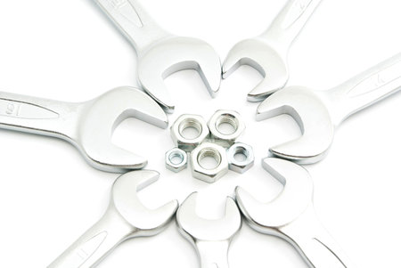 different wrenches and nuts on white background closeup