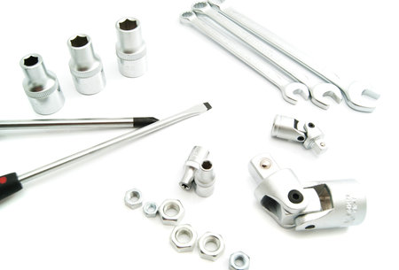 screwdrivers, various nuts and heads on white background