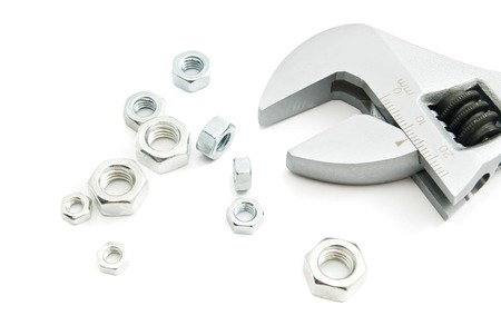 adjustable wrench and nuts on white background closeupの写真素材