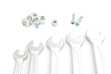 bolts and different wrenches closeup on whiteの写真素材