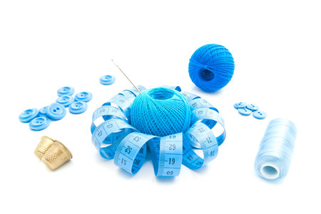 different blue items for needlework on white closeup