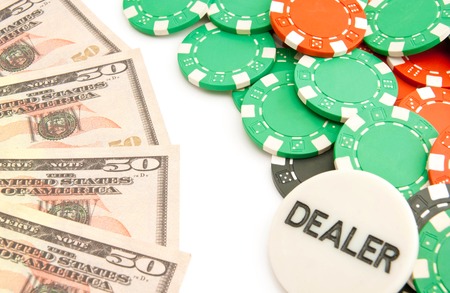 dollars and colored plastic chips on white backgroundの写真素材