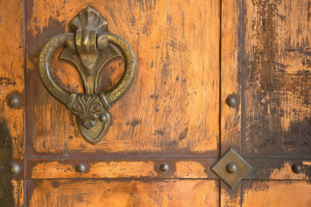 ornamental handle on old orange iron door