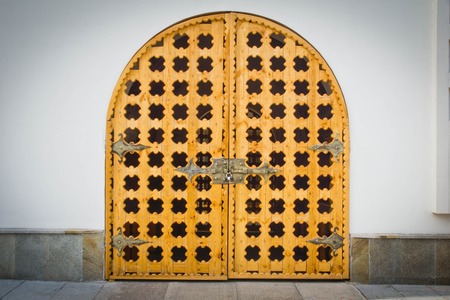 beautiful wooden gate in the wall of a buildingの写真素材