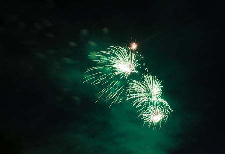 green fireworks in the dark night skyの写真素材