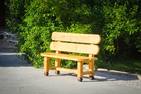 wooden bench in city park in summerの写真素材