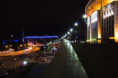 stadium and other buildings in the city at nightの写真素材