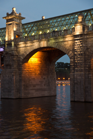 beautiful bridge over the river in the summer eveningの写真素材