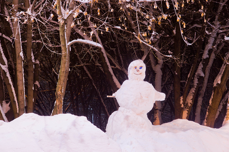 snowman in the evening in the winter parkの写真素材
