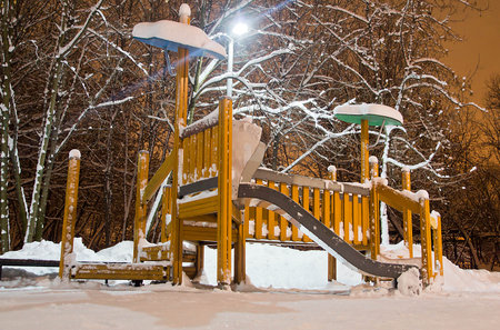 playground in the park in the winter night