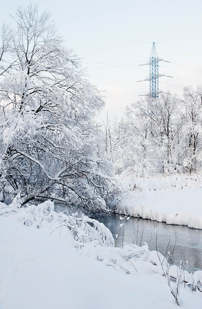 river and power line on winter dayの写真素材
