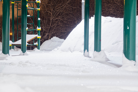 playground in a city park in the winter eveningの写真素材