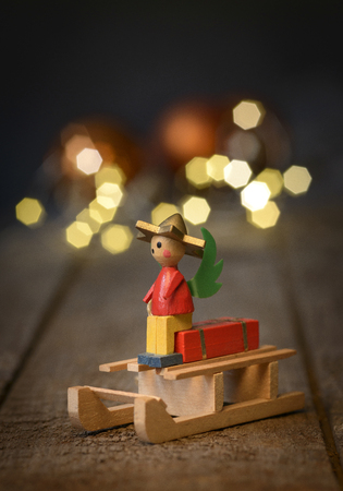 nostalgic christmas wooden sled decoration with antique toys over wooden background with space for textの写真素材