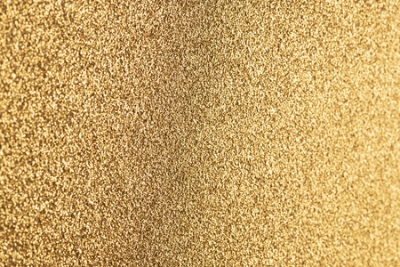 Detailed texture of glittering golden dust surface for christmasの写真素材