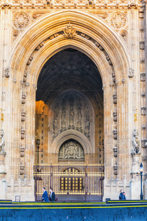 Houses of Parliament Sep 2014 in London. People walkinn in front of old church door and marble antique wallのeditorial素材