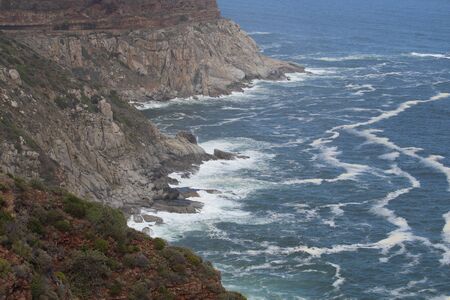 Waves crashing on cliffs coastlineの写真素材
