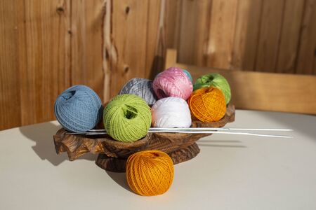 Colorful balls of thread with needles for knittingの写真素材