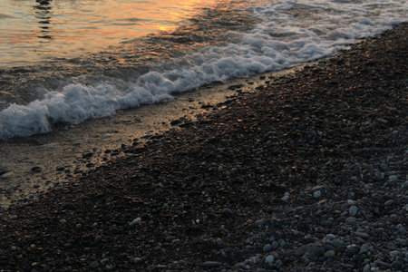 waves on the stone beach at sunset