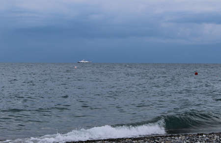 Boat in the sea stormy weather dark skyの写真素材