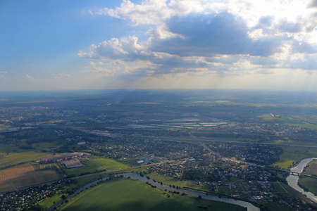 Aerial view of the city with sun rays coming through cloudsの写真素材