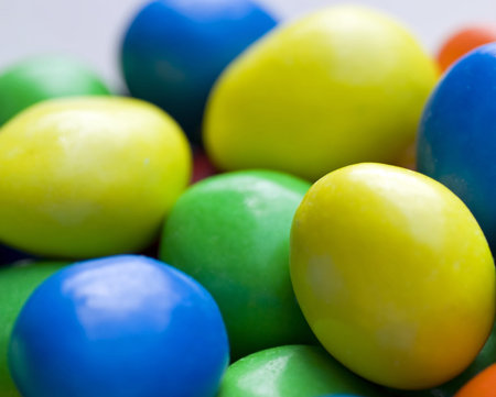 A photograph of green blue yellow and orange hard candies