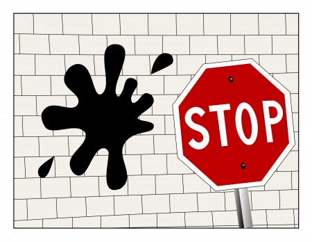 Stop sign in front on a splat on a brick wall の写真素材