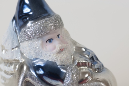 A Christmas tree ornament of a Santa Claus dressed in blue on his sleighの写真素材