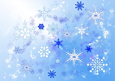 A drawing of swirling snowflakes in various sizes and designs on a blue backgroundの写真素材