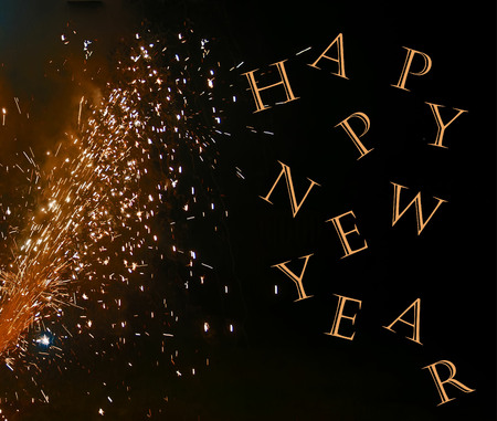 A photo of a fireworks display on a black background enhanced with the text, Happy New Yearの写真素材