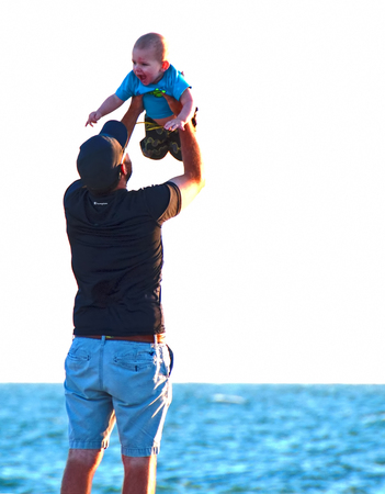 A photo of a father playing with his son at the beachのeditorial素材