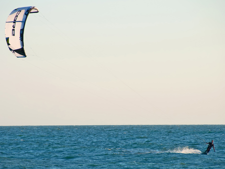 A photo of a man kiteboarding close to the shore in the Gulf of Mexico near Sarasota Floridaのeditorial素材