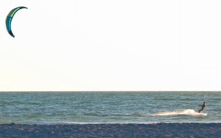 A photo of a man kiteboarding close to the shore in the Gulf of Mexico near Sarasota Floridaのeditorial素材